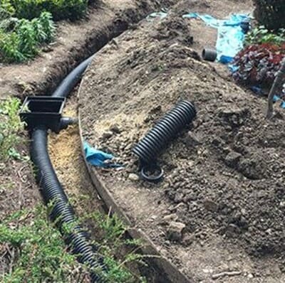 Black corrugated pipe installation for efficient yard drainage solutions