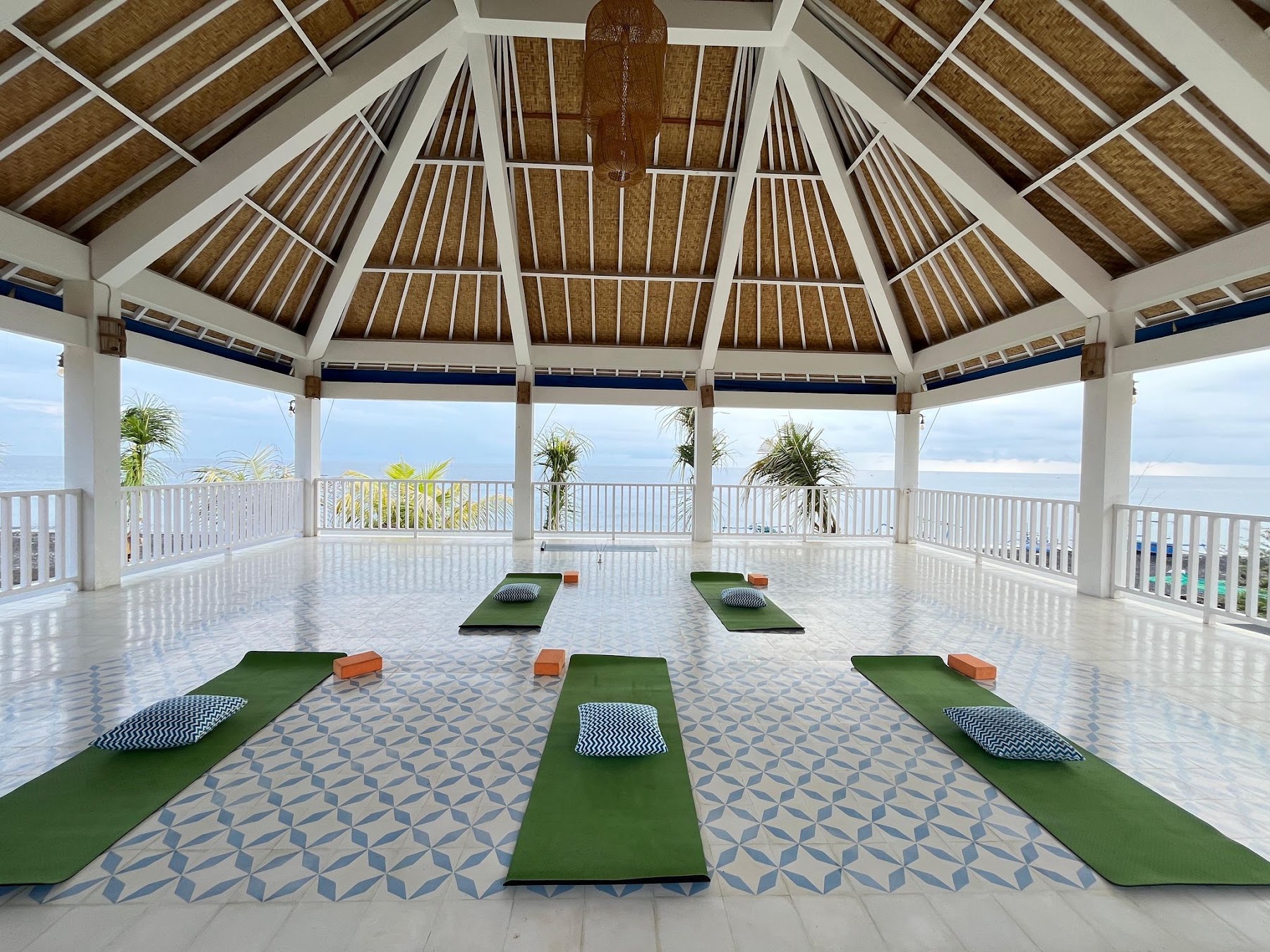 Open air yoga shala with mats laid out, looking out to sea at Ocean Paradise