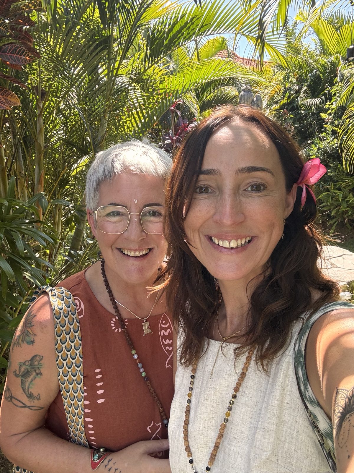 Retreat hosts Lisa Jo and Carolyn Clark smiling together in a tropical garden in Bali