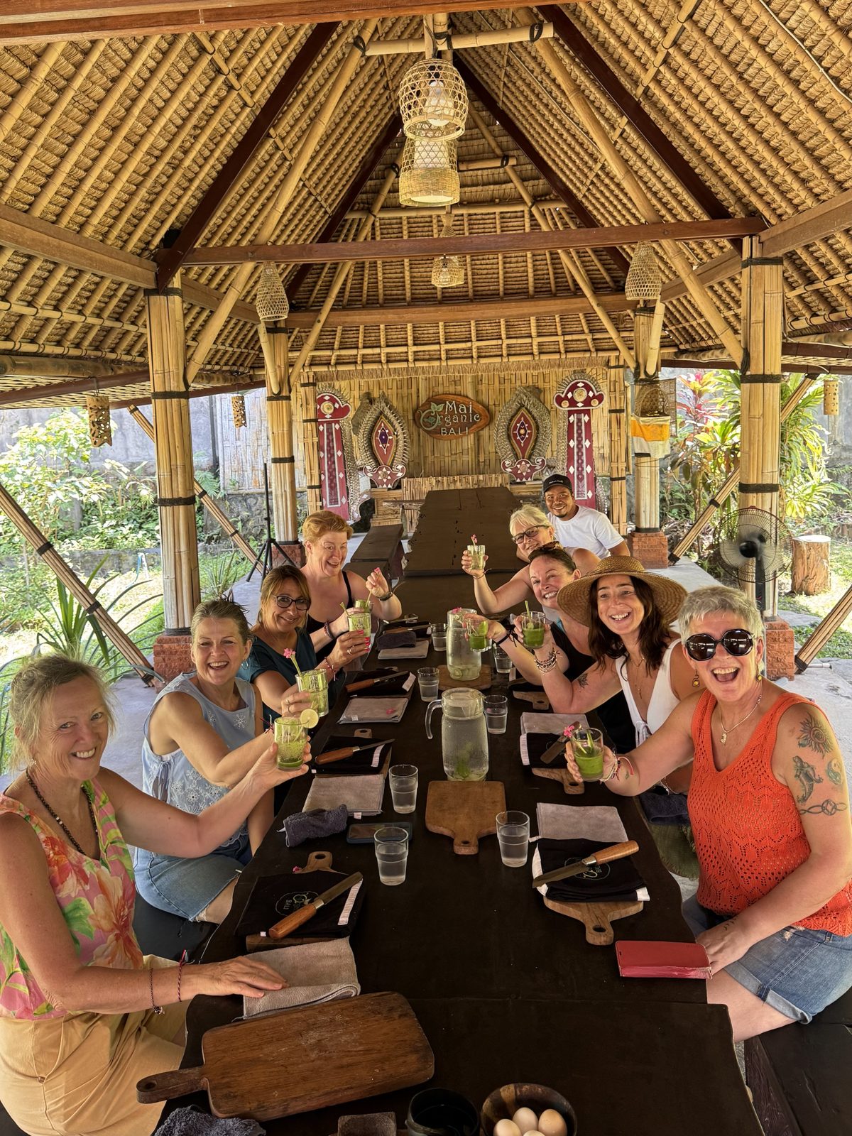 Retreat guests raising a toast together at Mai Organic in Bali