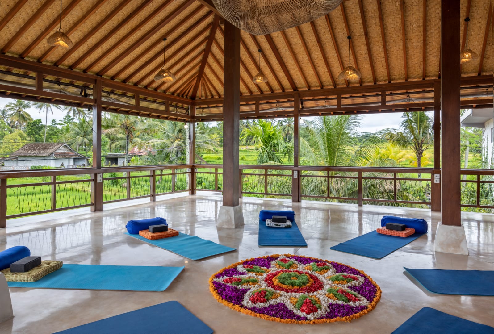 Yoga shala set up with mats and a flower mandala