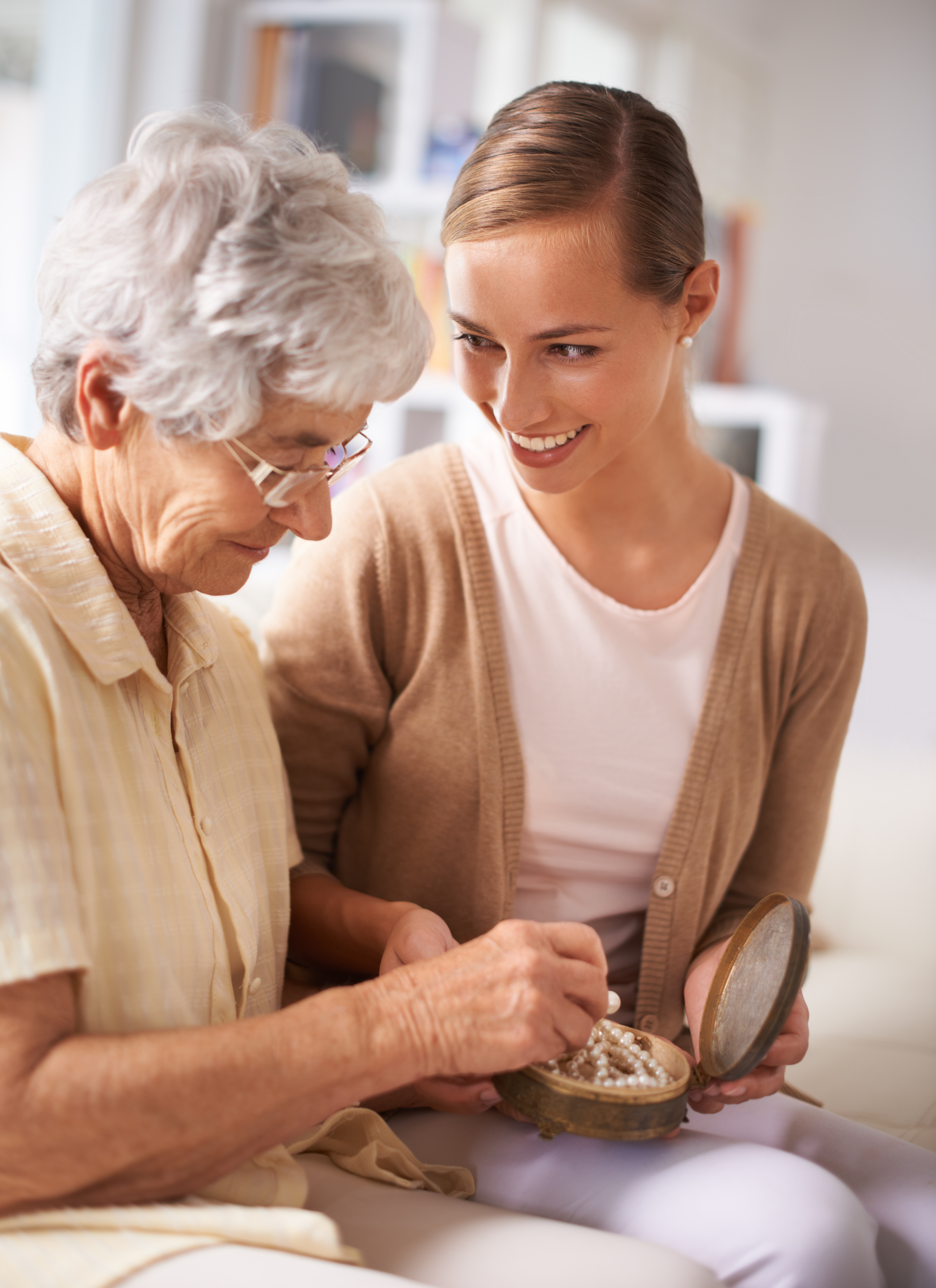 A senior woman sharing a moment with her daughter at home