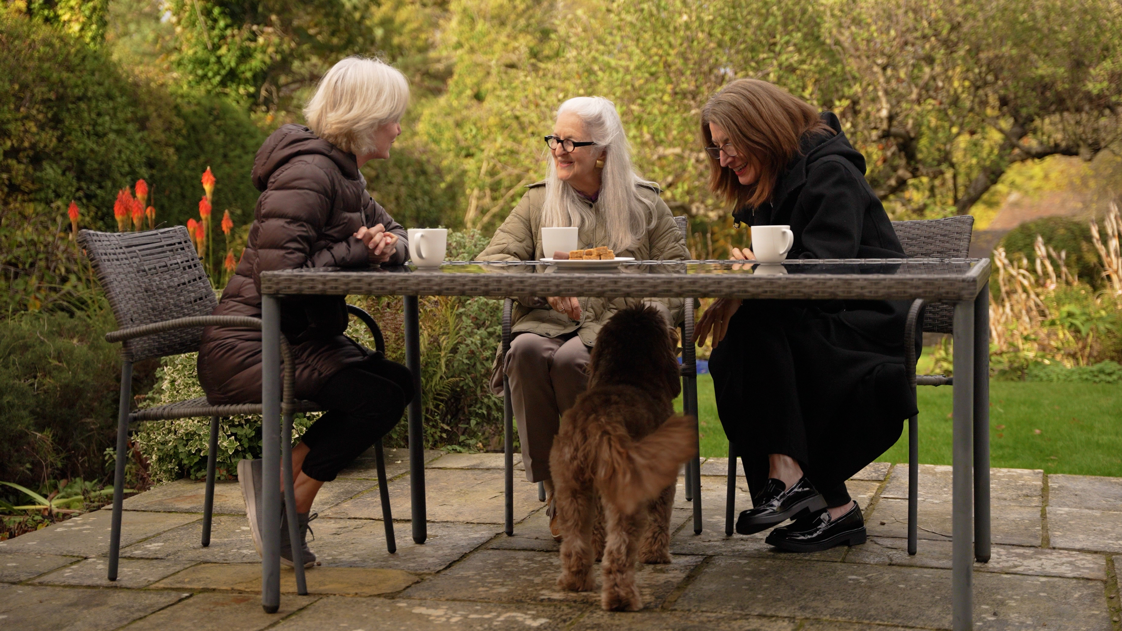 Family and friends enjoying tea together in the garden