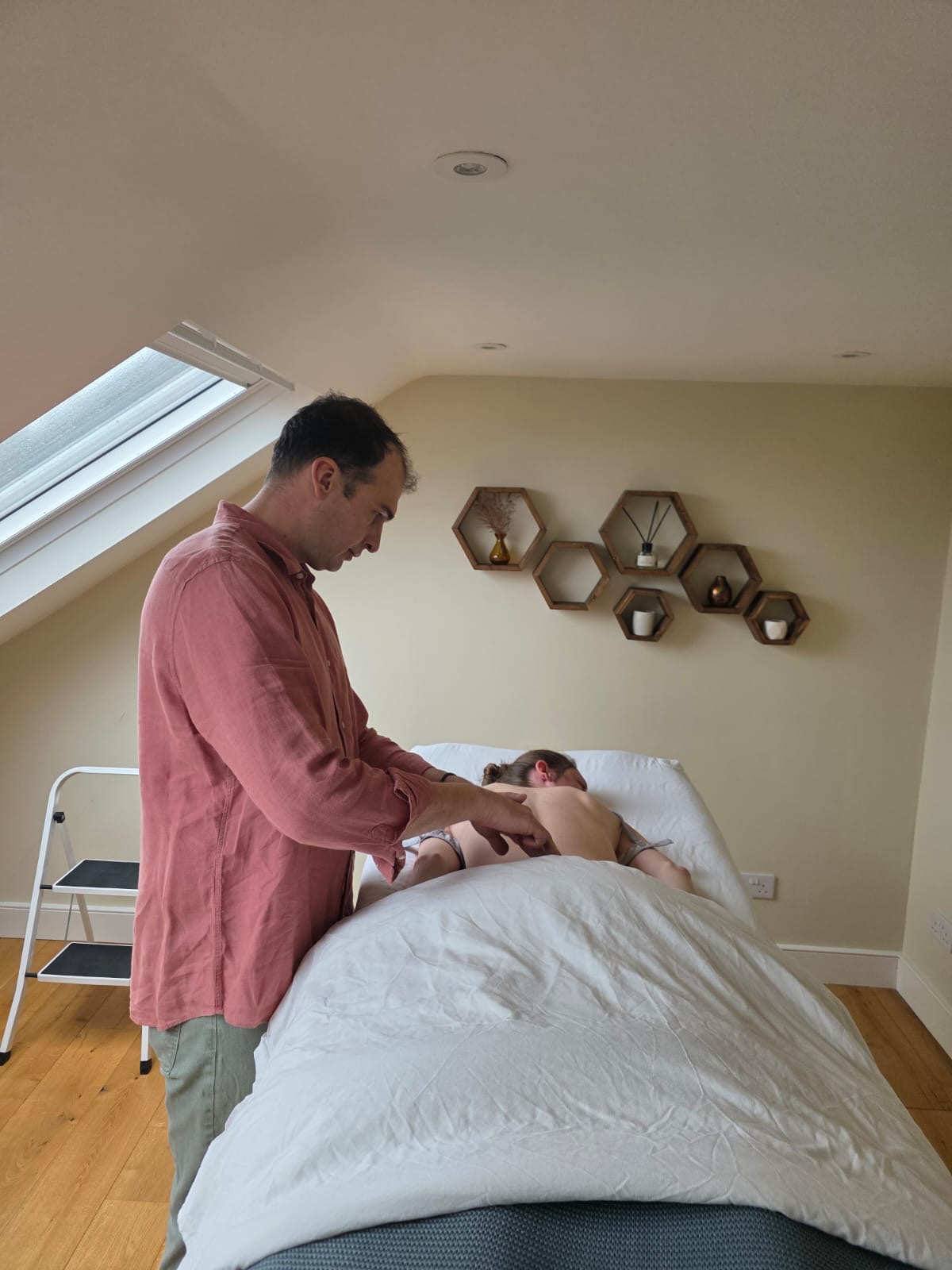 Jono Goosen focused while performing a hands-on MyoReformation session on a client in London