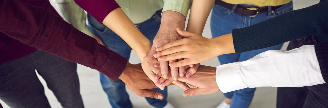 Hands joined together in a circle, representing community support
