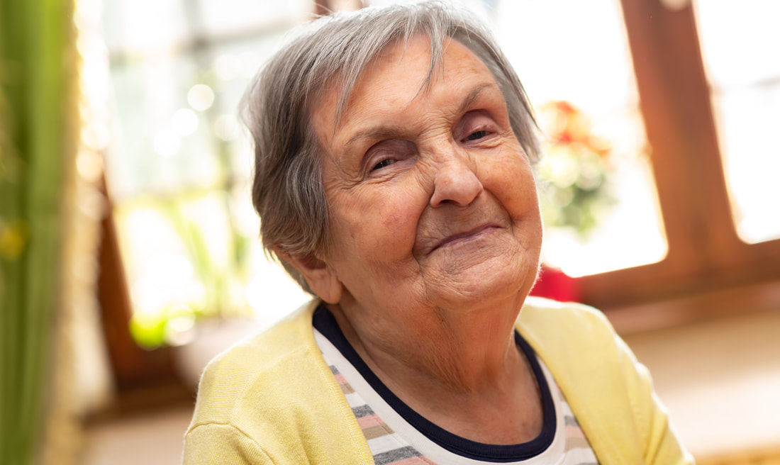 Older adult smiling in a warm and welcoming setting
