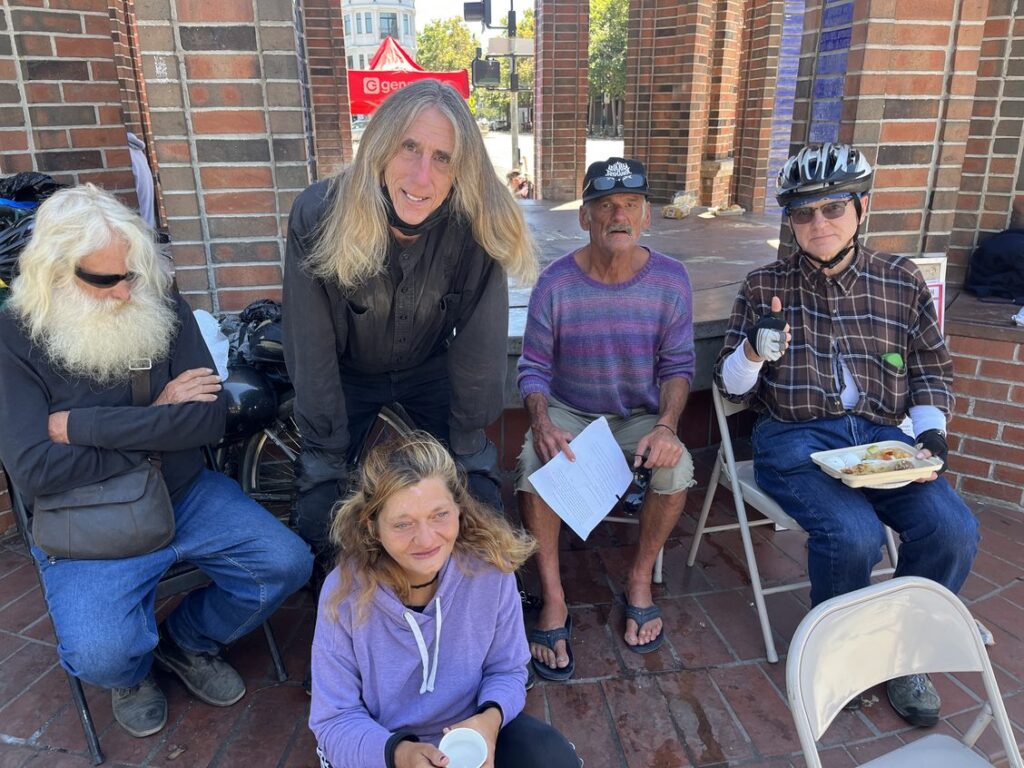 A group of people gathered together, representing gentle support, connection and community