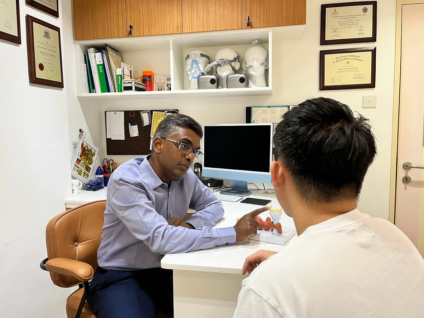 Dr Soma consulting a patient