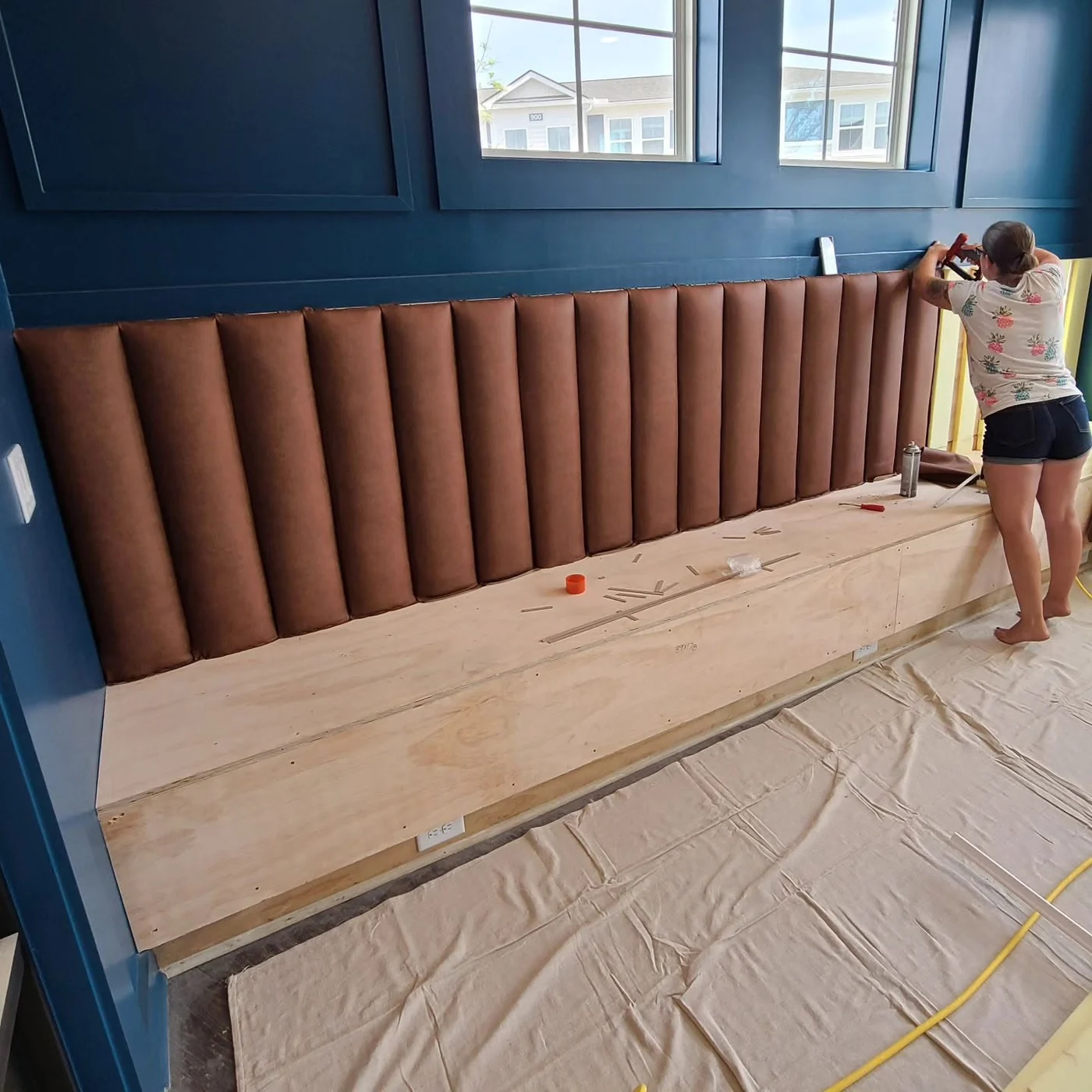 MK's upholsterer installing padding during a banquette upholstery project