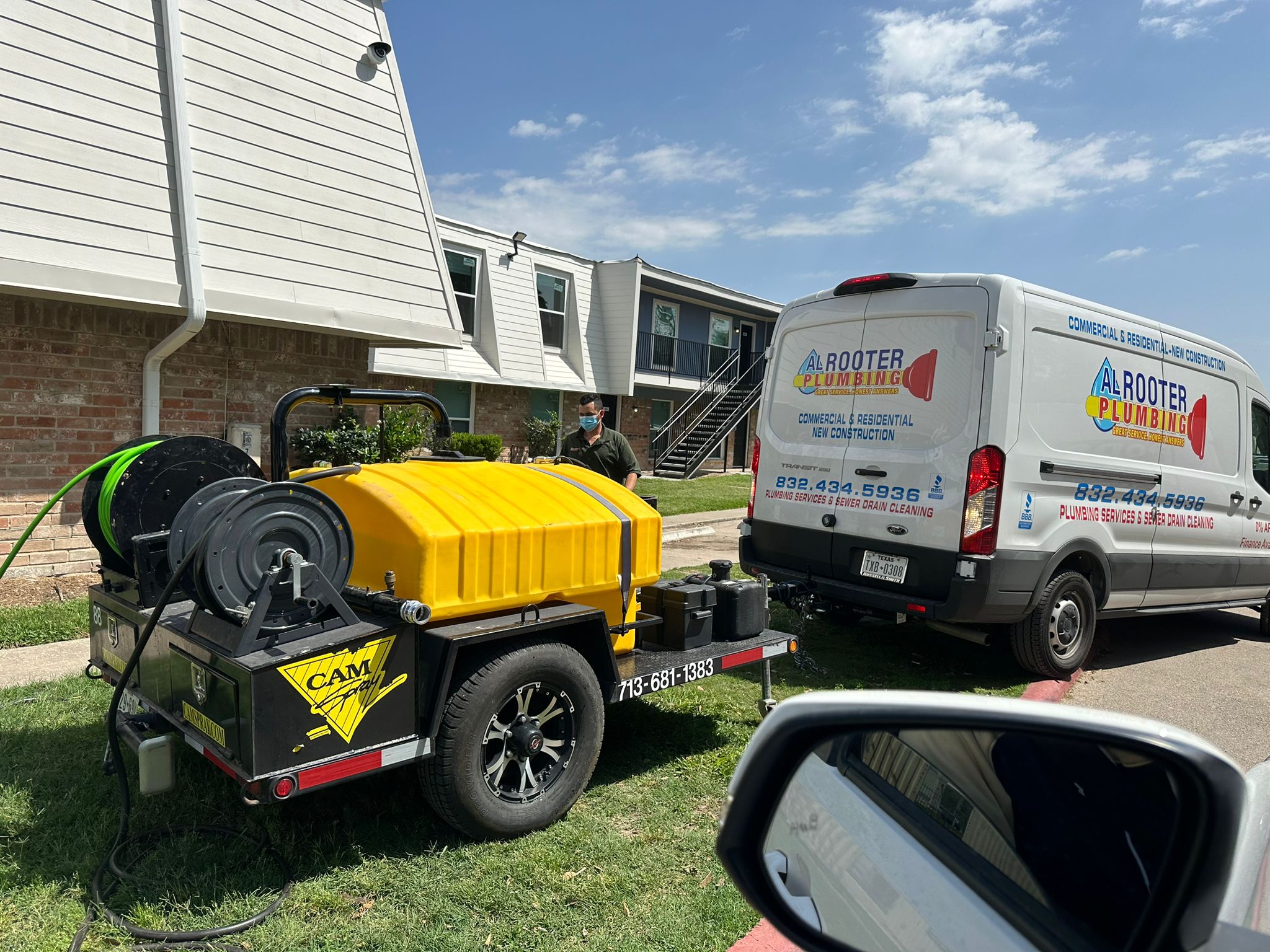 Plumber marking the location of a buried residential gas line with flags and tape