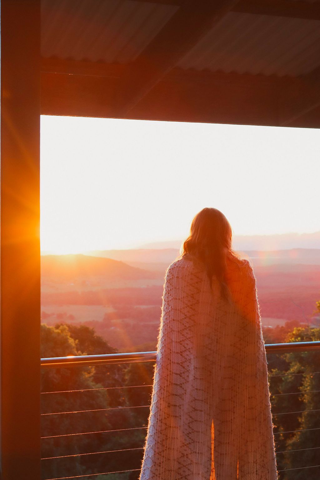 A bride on the verandah at sunset