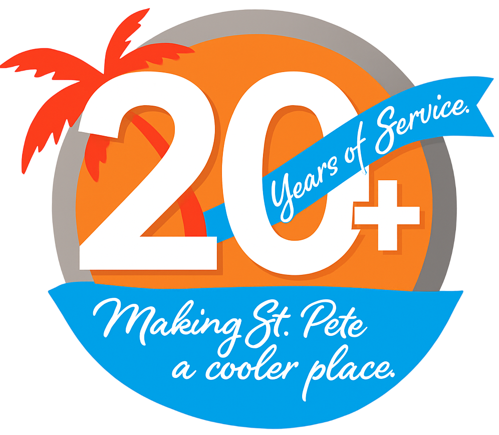 Total Air Inc. technician smiling in front of home with 20 years of service badge – trusted AC repair company in St. Petersburg FL