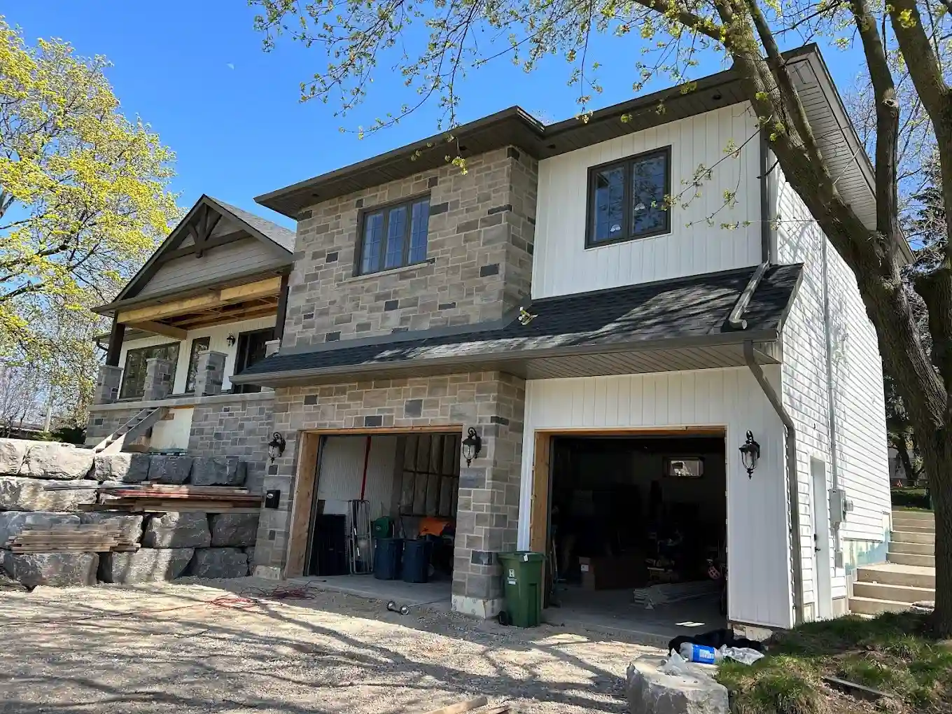 Luxury stone home with custom seamless gutters and exterior drainage system
