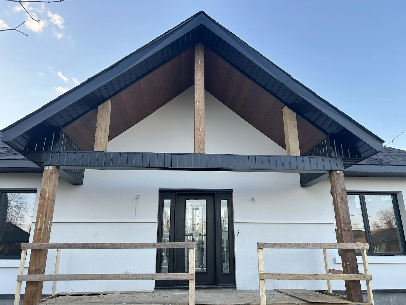 Modern wood soffit and black aluminum gutter installation by Infinity Gutters
