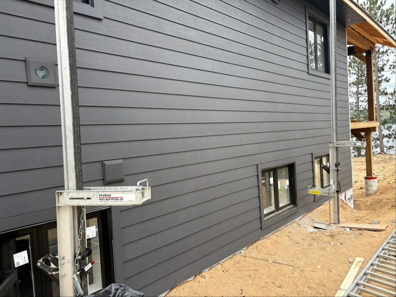 Modern Toronto-area home with dark grey horizontal siding and black-framed windows