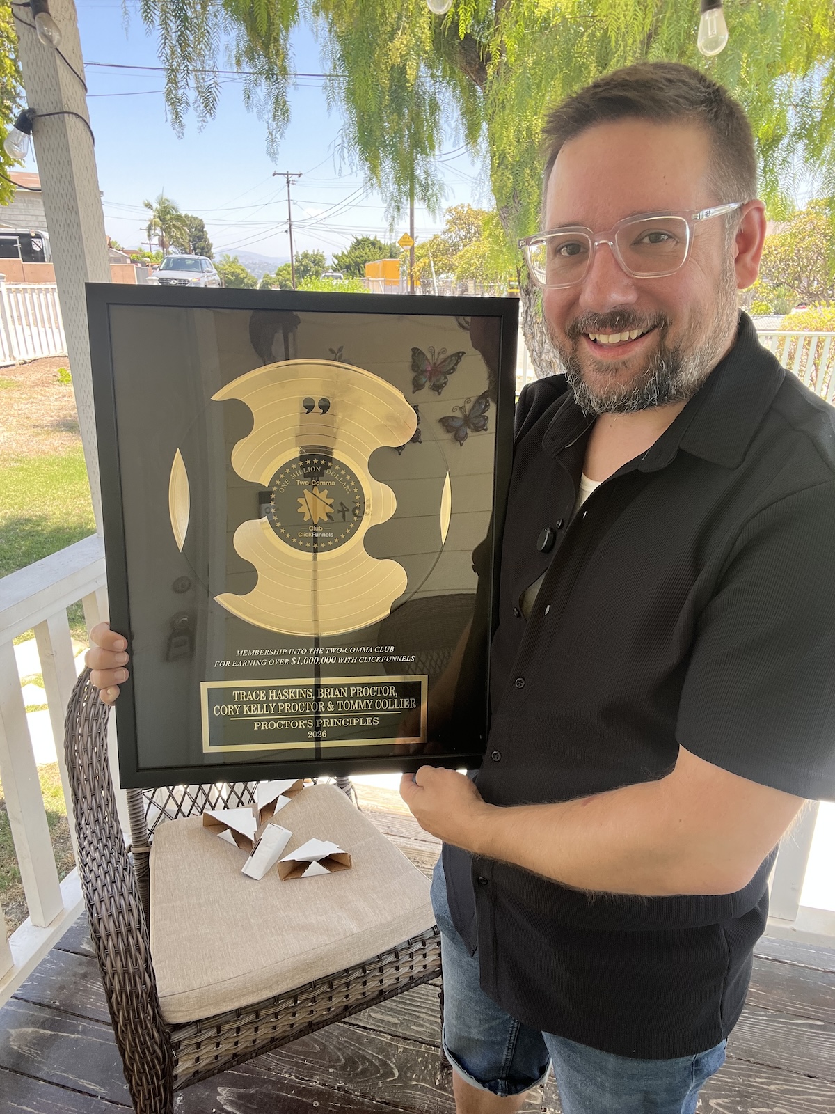 Trace holding his 2 Comma Club Award