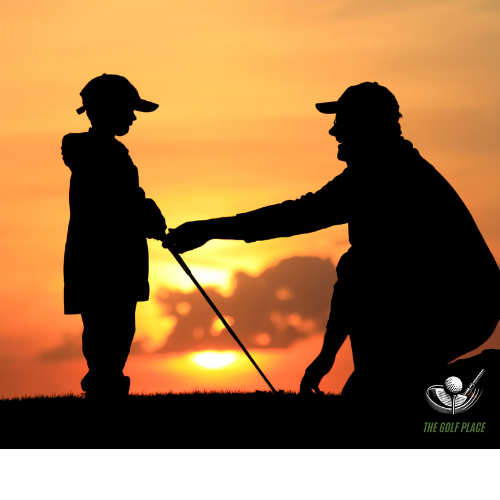 Golf instructor teaching student at sunset