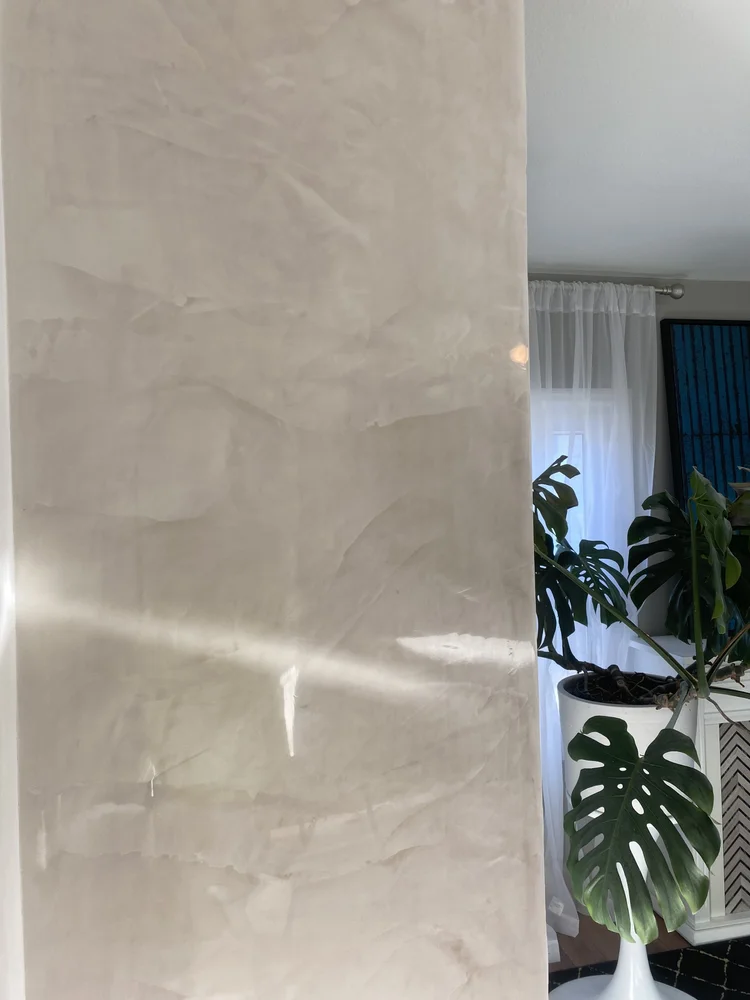 Hand-applied Venetian plaster architectural column with soft neutral movement and polished sheen