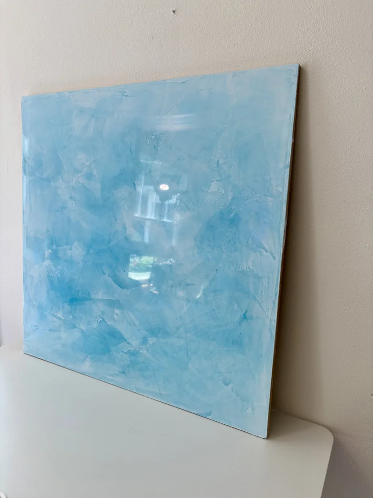 Custom blue Venetian plaster sample showcasing hand-applied movement, depth and polished sheen