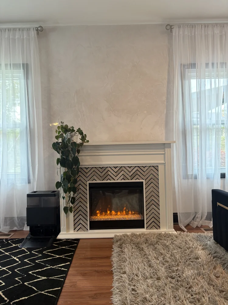 Custom Venetian plaster fireplace feature wall creating a soft luxury finish in a St. Louis living room