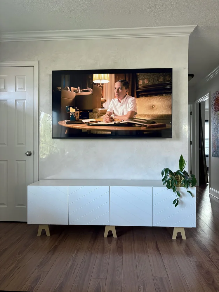 Polished Venetian plaster TV feature wall with luminous neutral finish in a modern interior