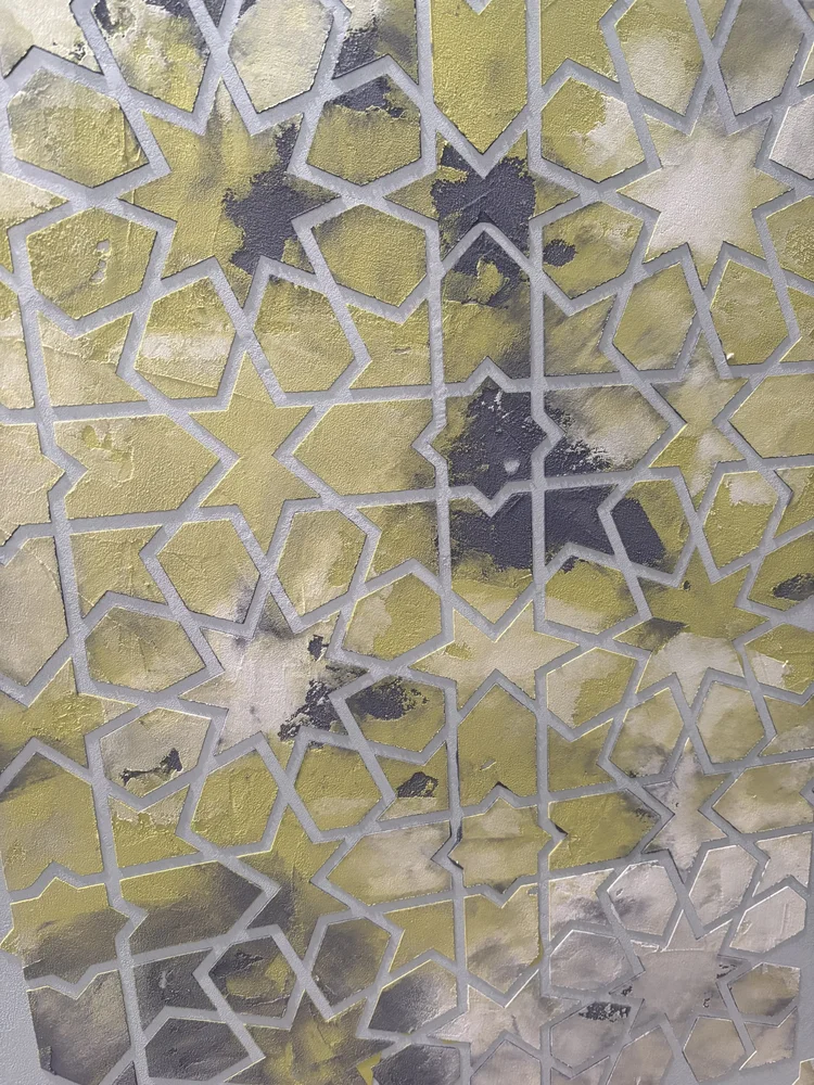 Custom decorative plaster finish with raised geometric pattern and hand-applied gold detailing