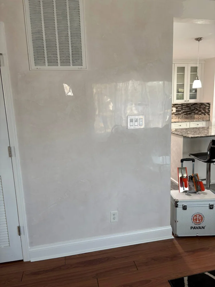 Light polished Venetian plaster wall with soft movement and reflective finish in a St. Louis home