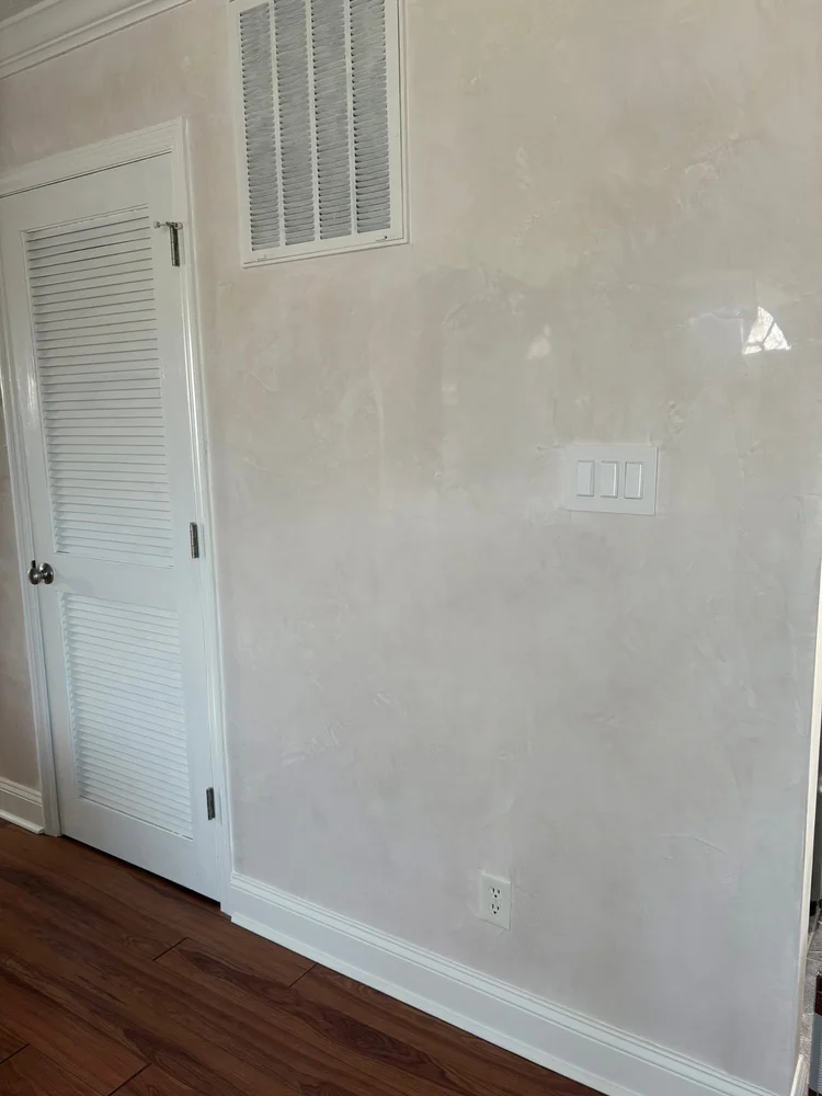 Neutral Venetian plaster wall with subtle movement and luminous polished finish