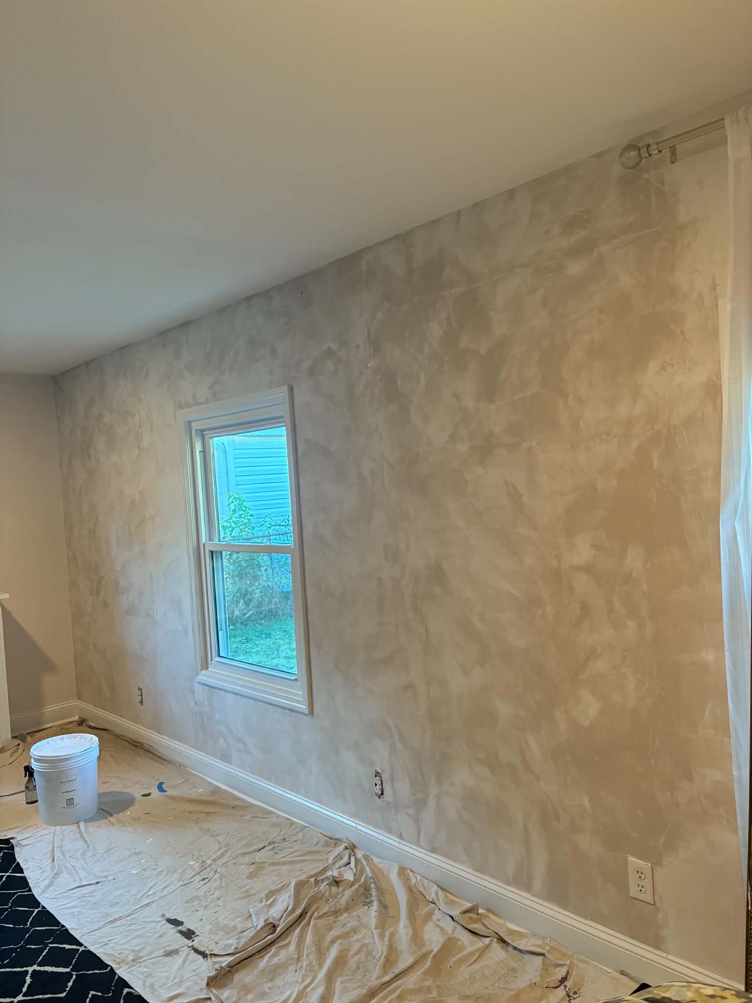 Warm neutral Venetian plaster feature wall with soft movement and handcrafted texture in St. Louis