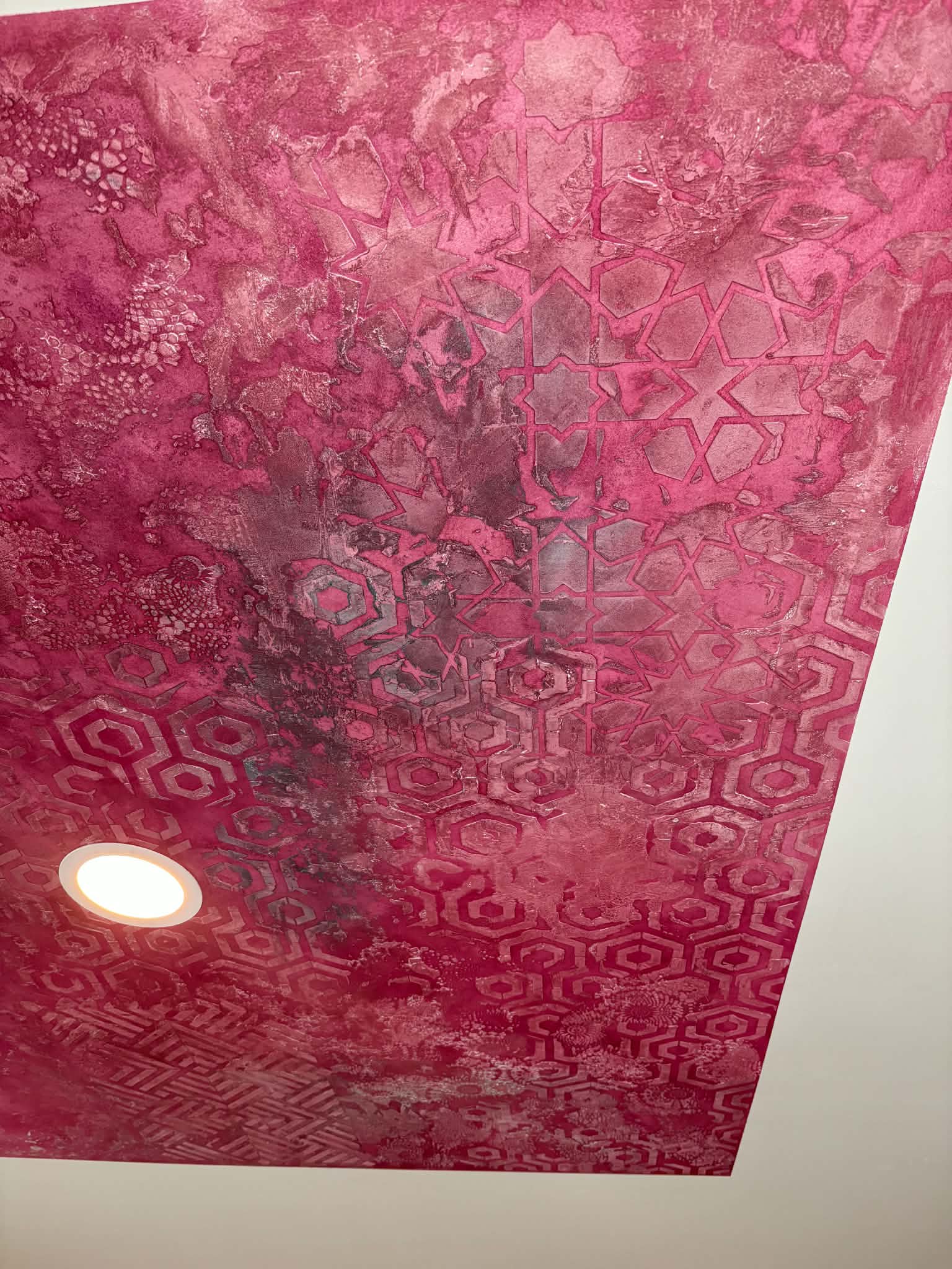 Custom pink decorative plaster ceiling with layered geometric texture and hand-applied detailing