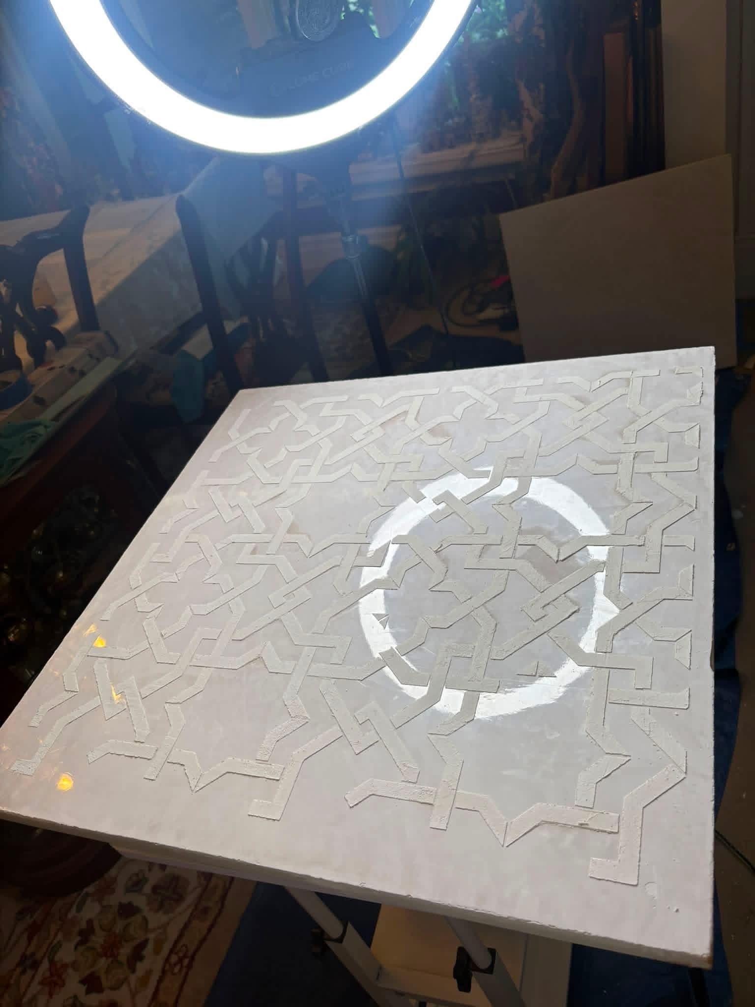 Handcrafted Venetian plaster sample with raised geometric texture and polished reflective finish