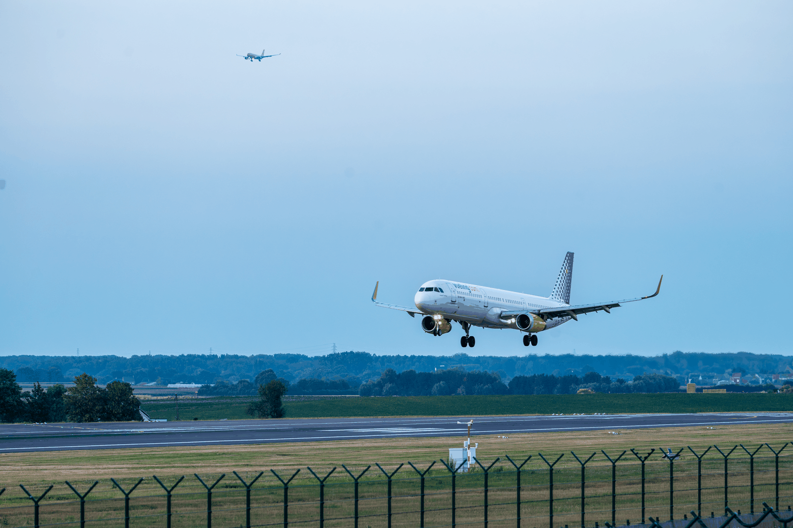A commercial aircraft about to land at an airport