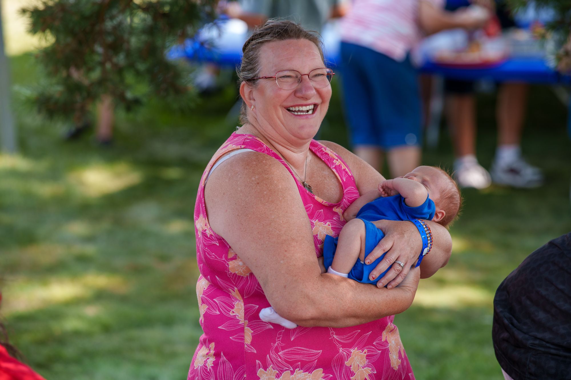 A grandmother laughing with a baby