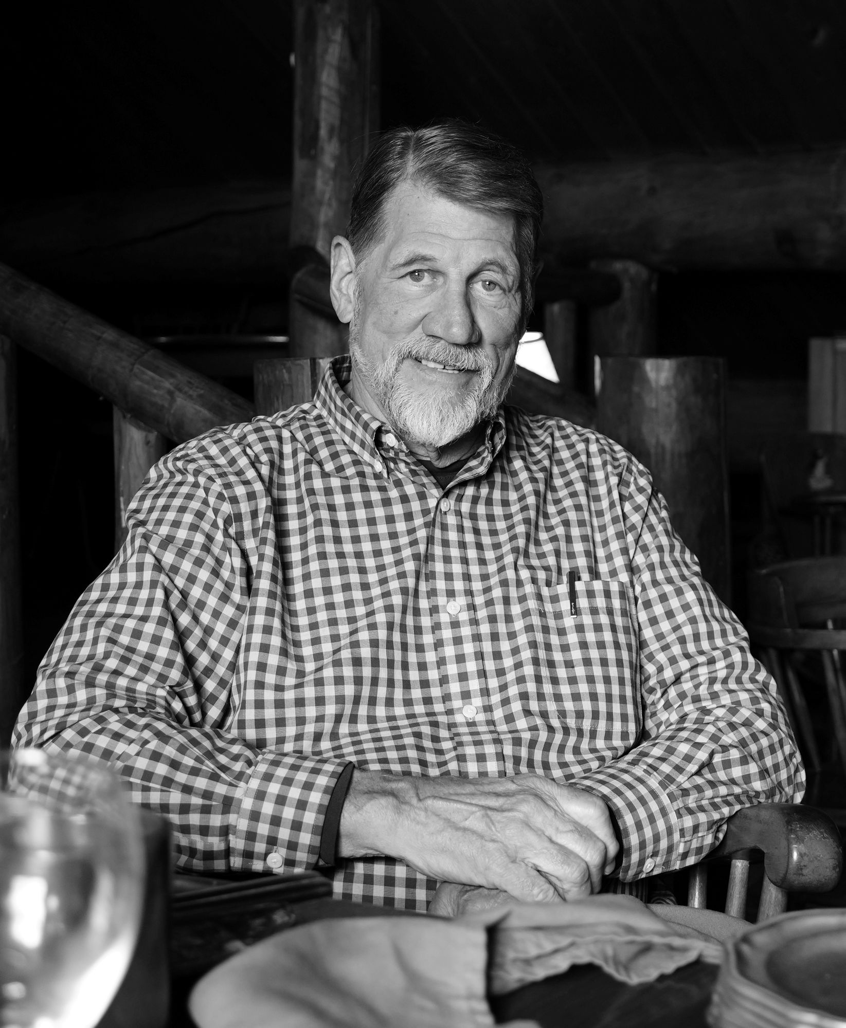 An older man in a plaid shirt