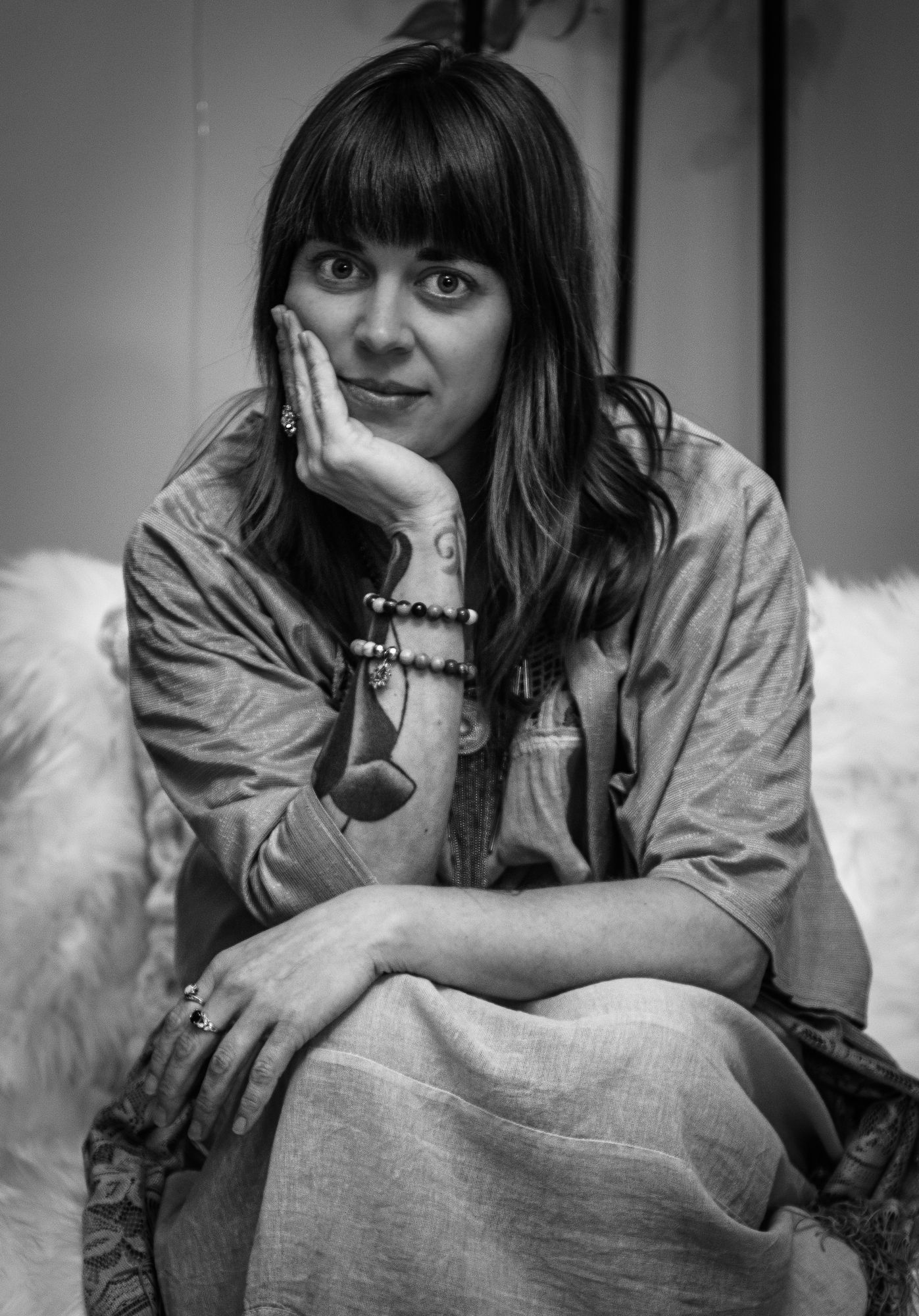 A woman resting her chin on her hand in a portrait