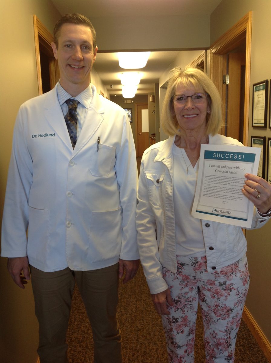 Patient with Dr. Hedlund holding her success story