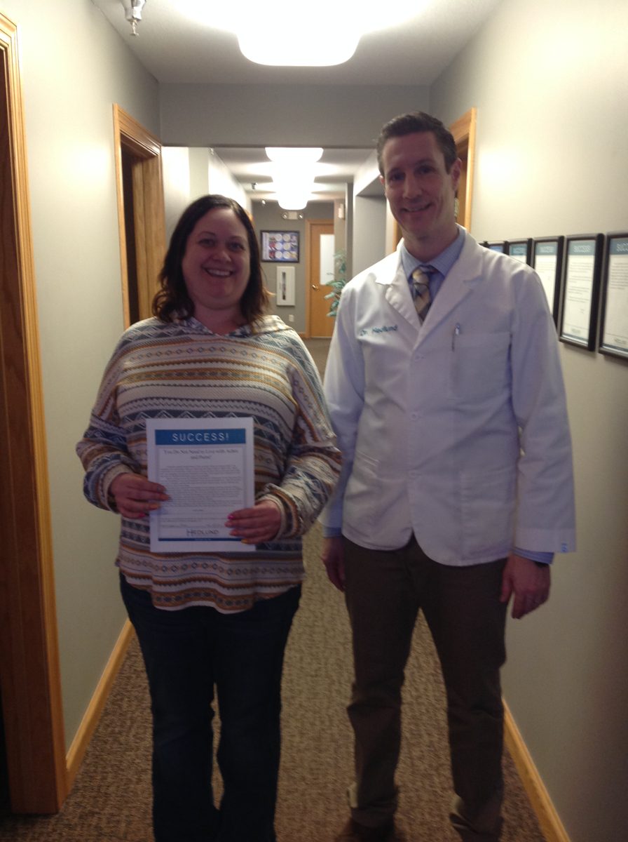 Patient with Dr. Hedlund holding her success story