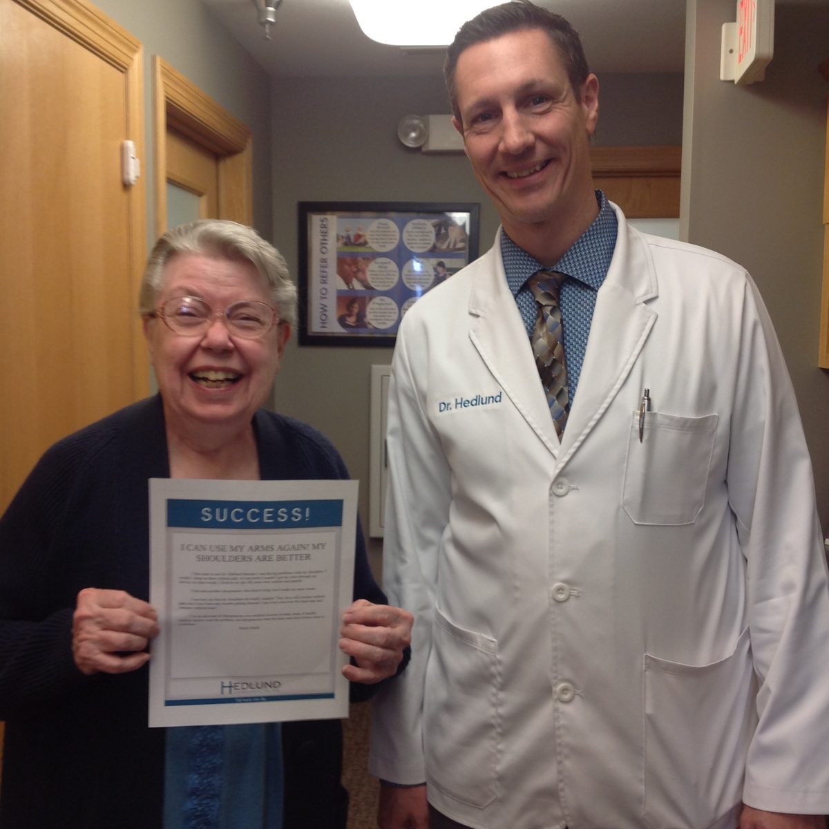 Patient with Dr. Hedlund holding her success story