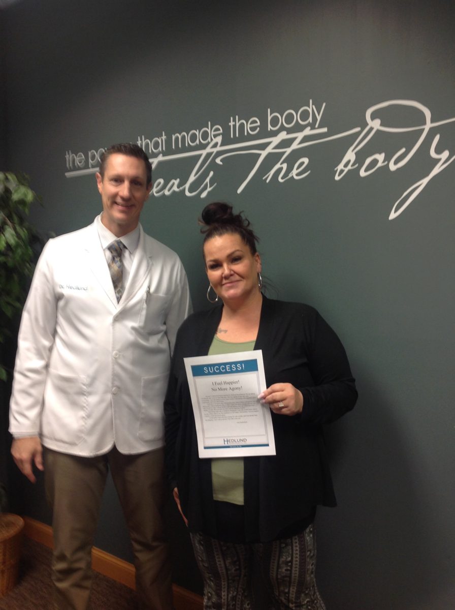 Patient with Dr. Hedlund holding her success story
