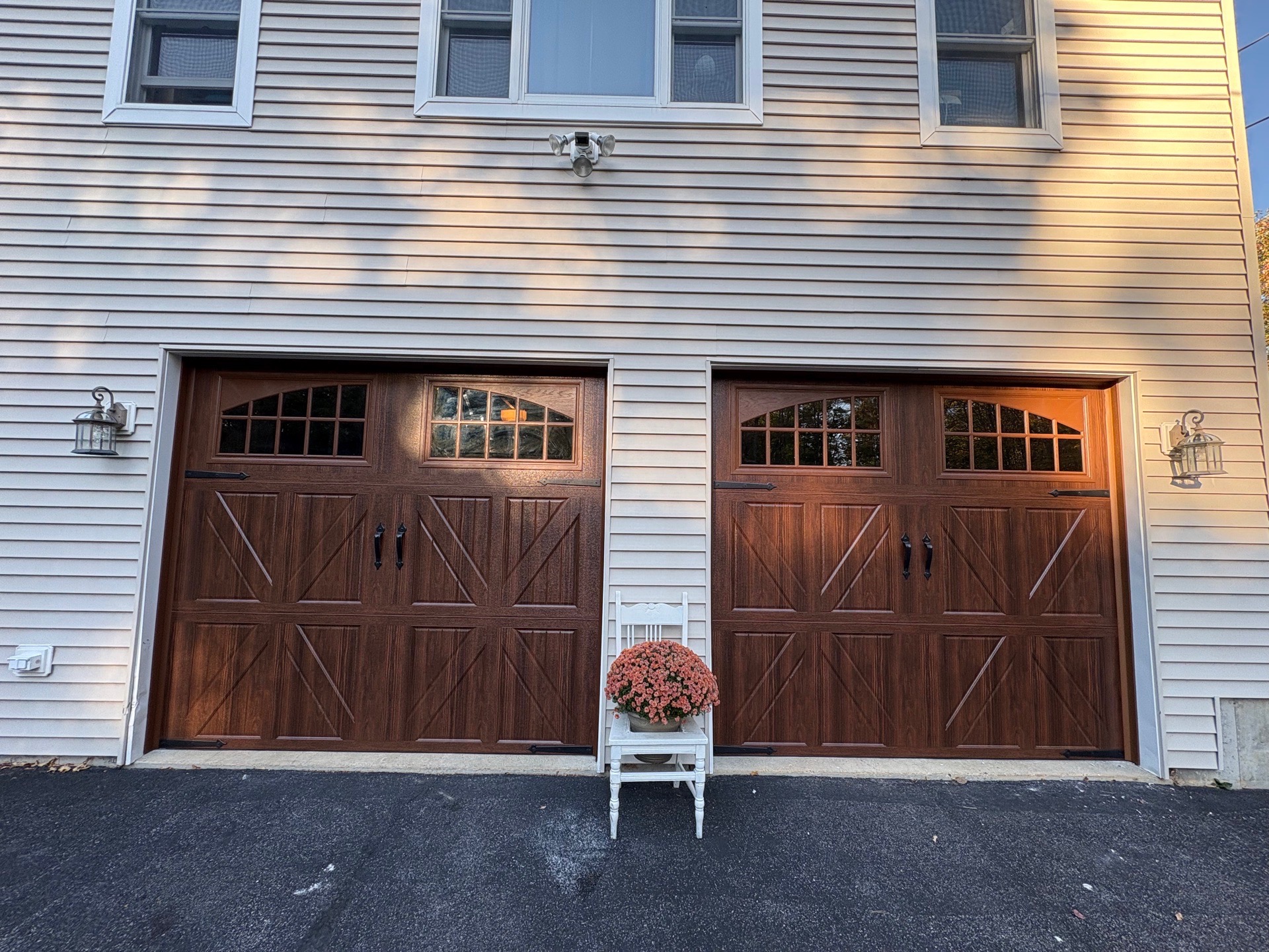 Double carriage-style door installation — warm wood finish, southern Maine