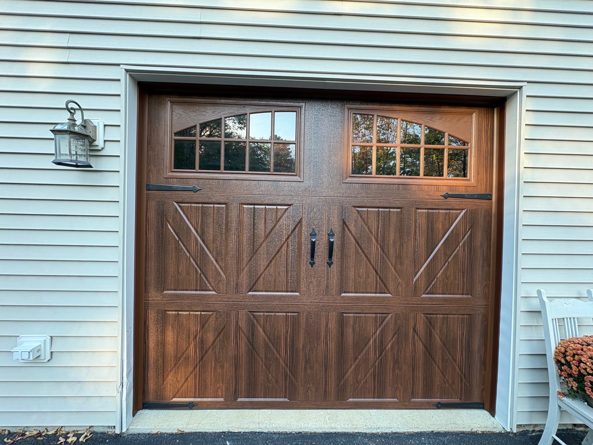 Carriage door detail — arched windows and custom hardware