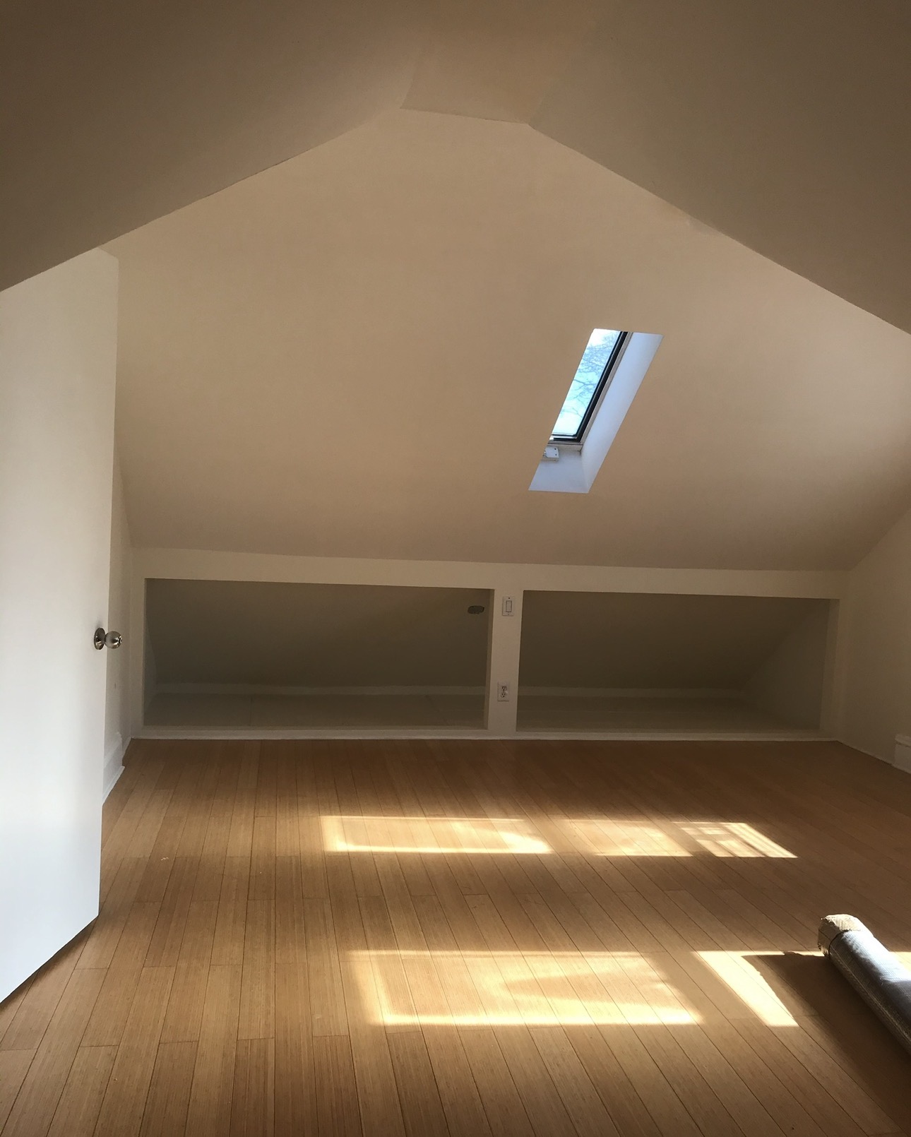 Vaulted ceiling build-out with skylight and built-in shelving