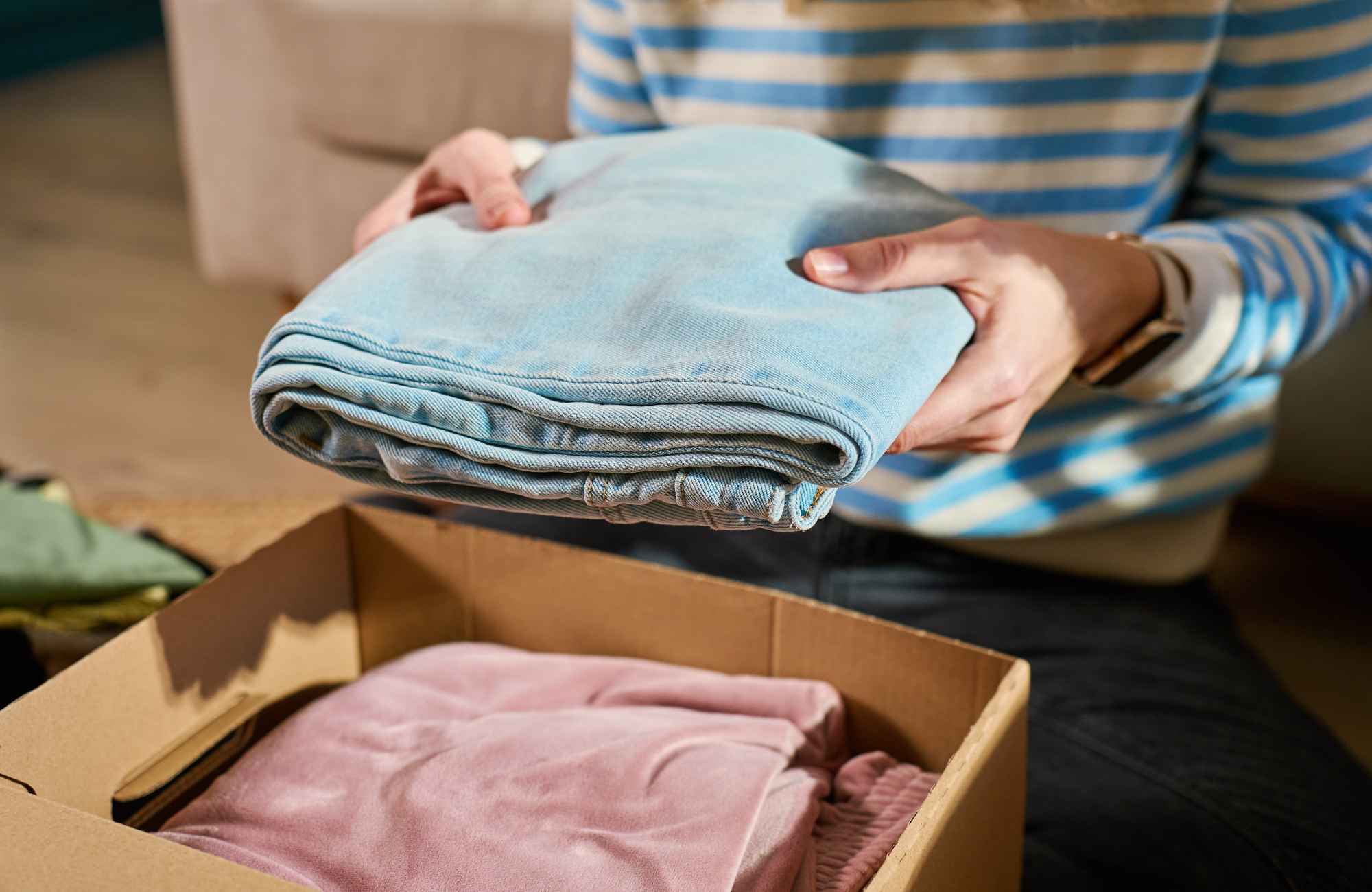 move-management-sedona-az-organizing-for-spring-move-woman-packing-clothes-into-box-orderly-life-changing