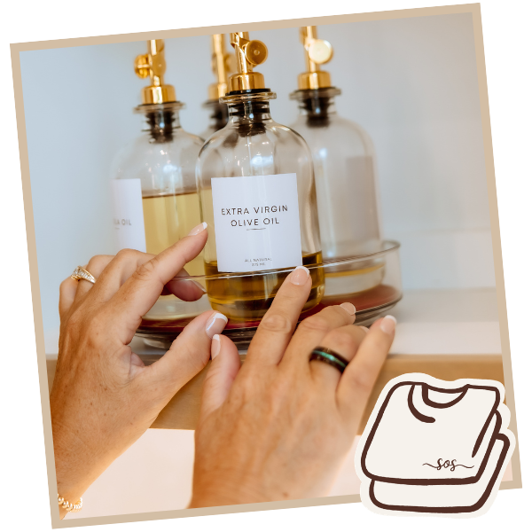 Professional home organizer arranging labeled glass oil bottles on a pantry turntable