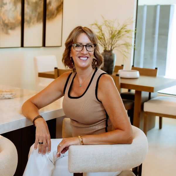 GIF of Shannon sitting on kitchen counter smiling at camera