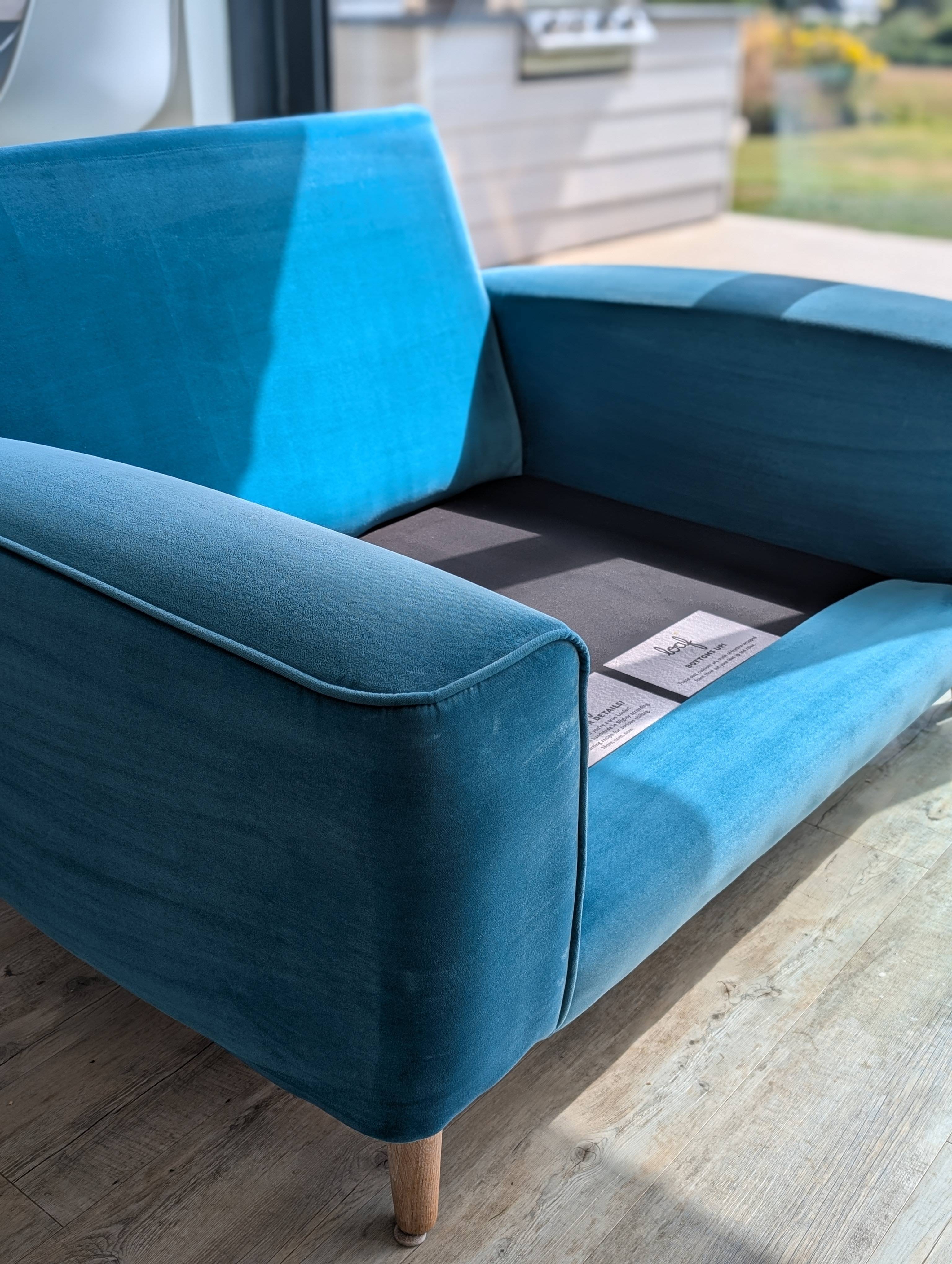 Beautifully restored teal velvet sectional sofa after professional cleaning