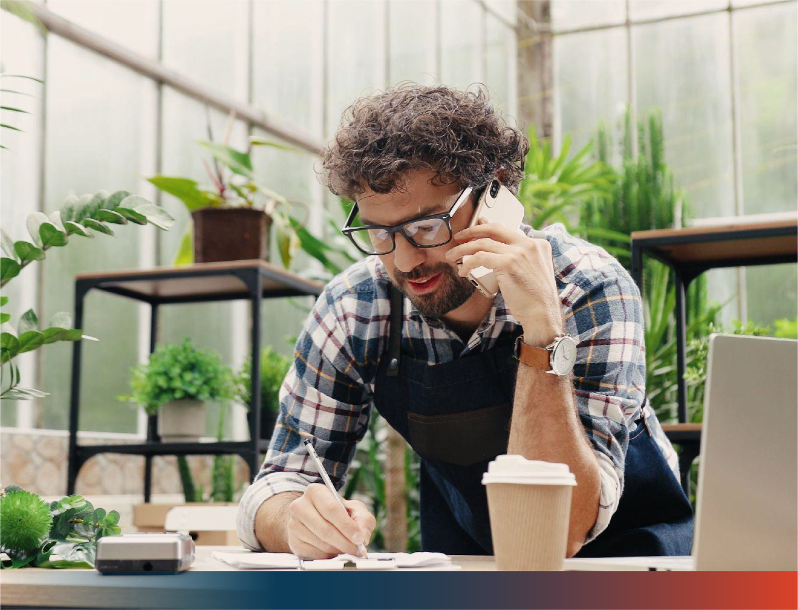 Man on the phone writing notes