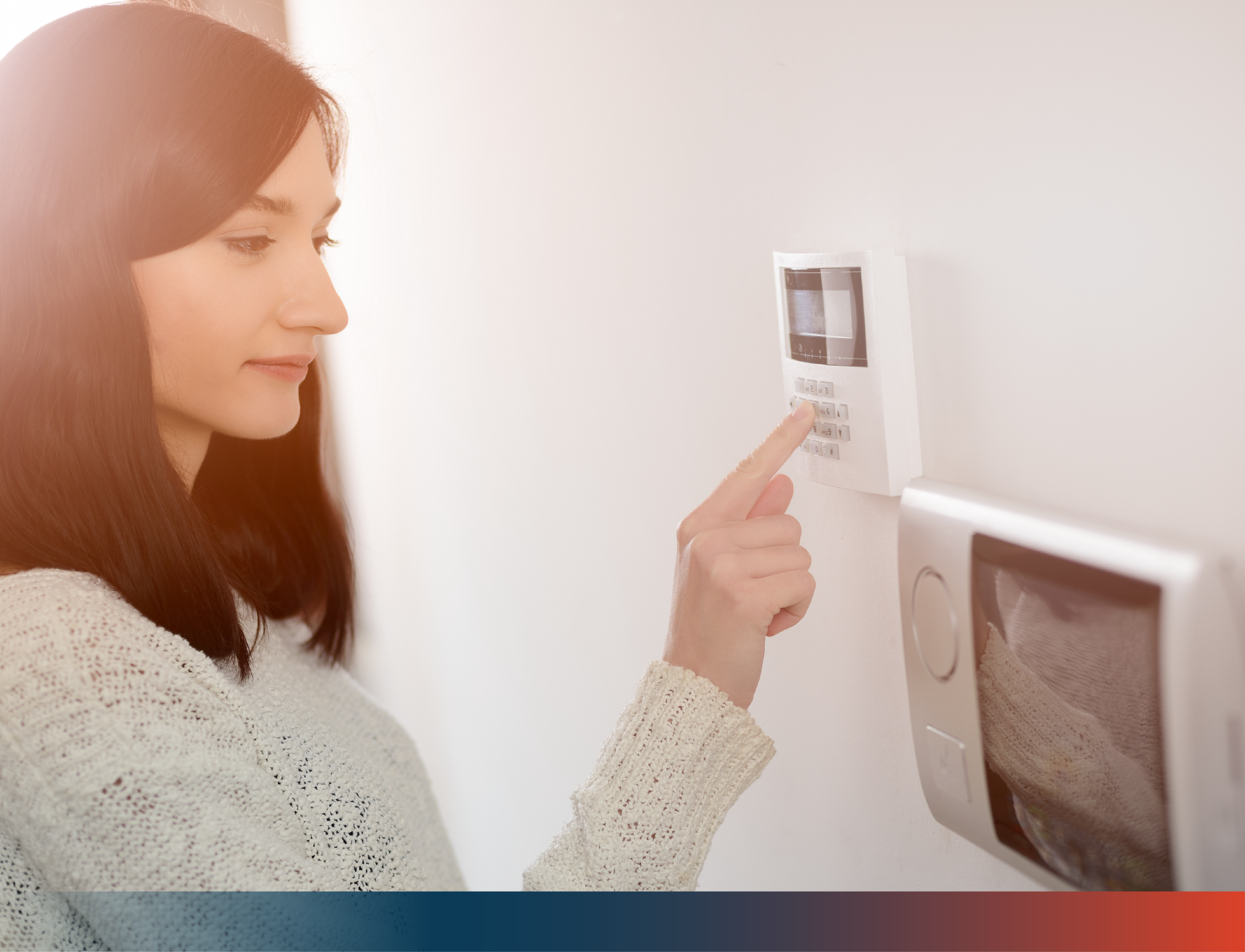 Woman setting up security alarm