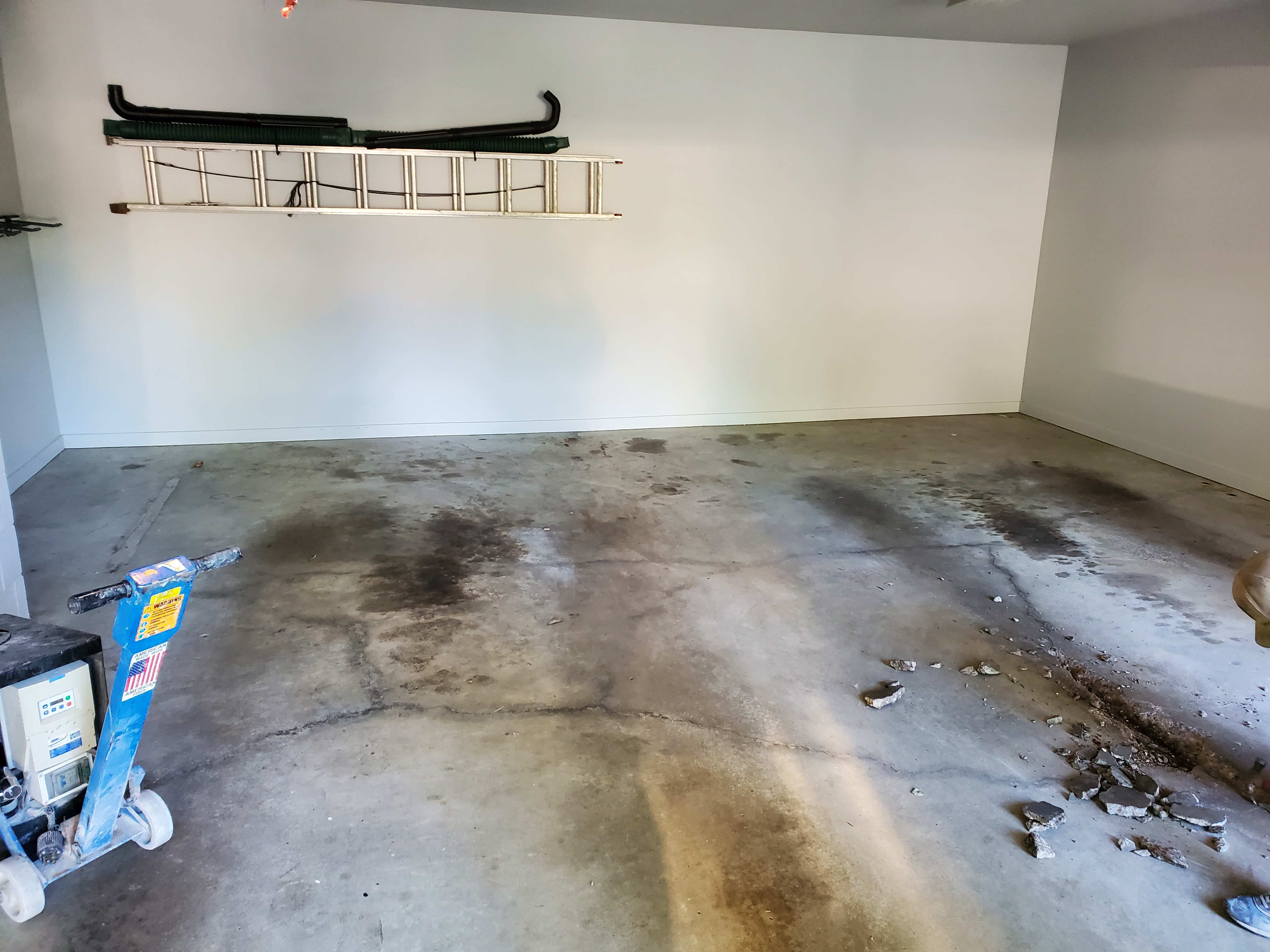 Bare concrete Kansas City garage floor assessed during free on-site estimate
