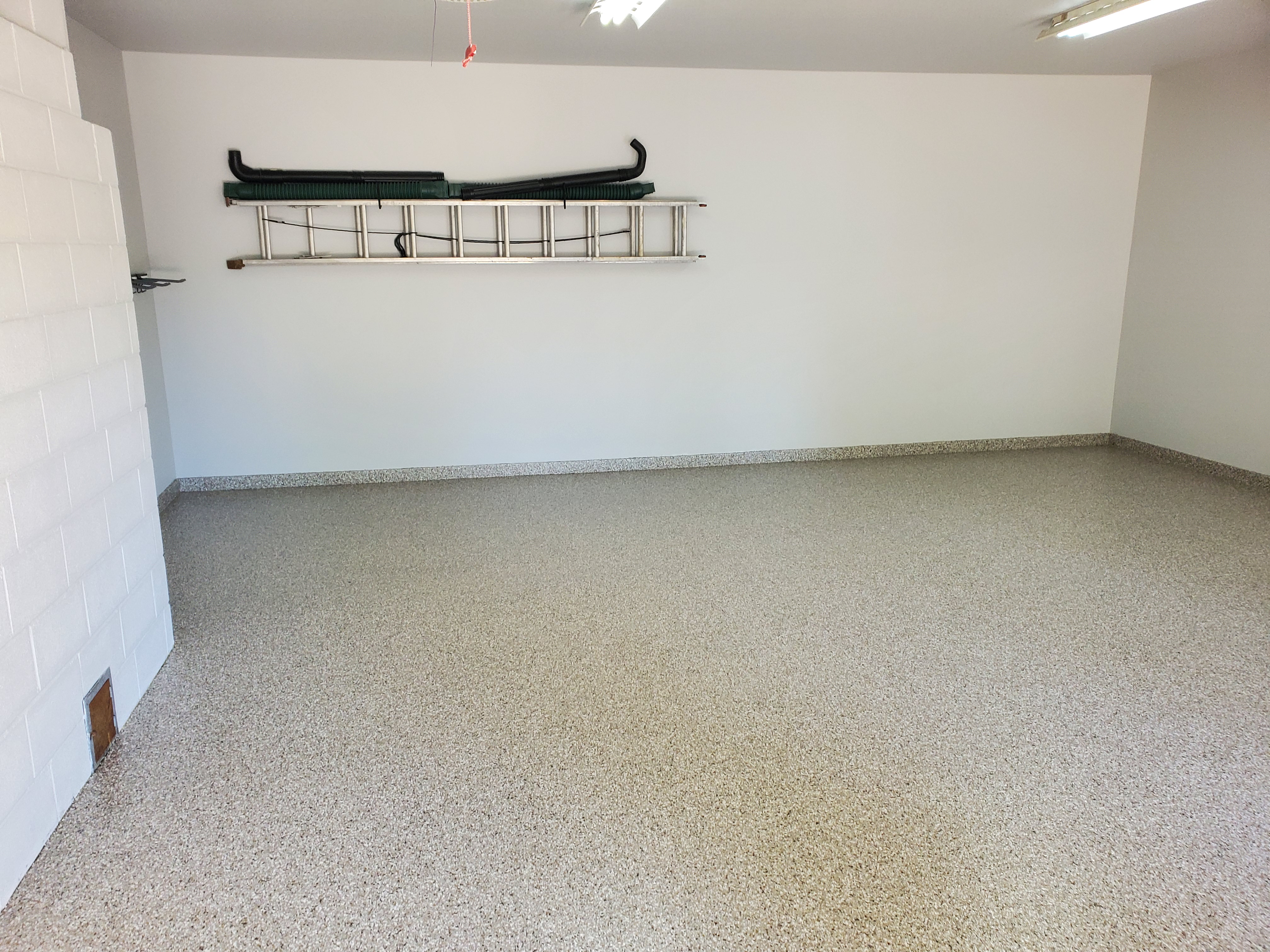 Finished epoxy flake garage floor after Coating Commander installation Kansas City Metro
